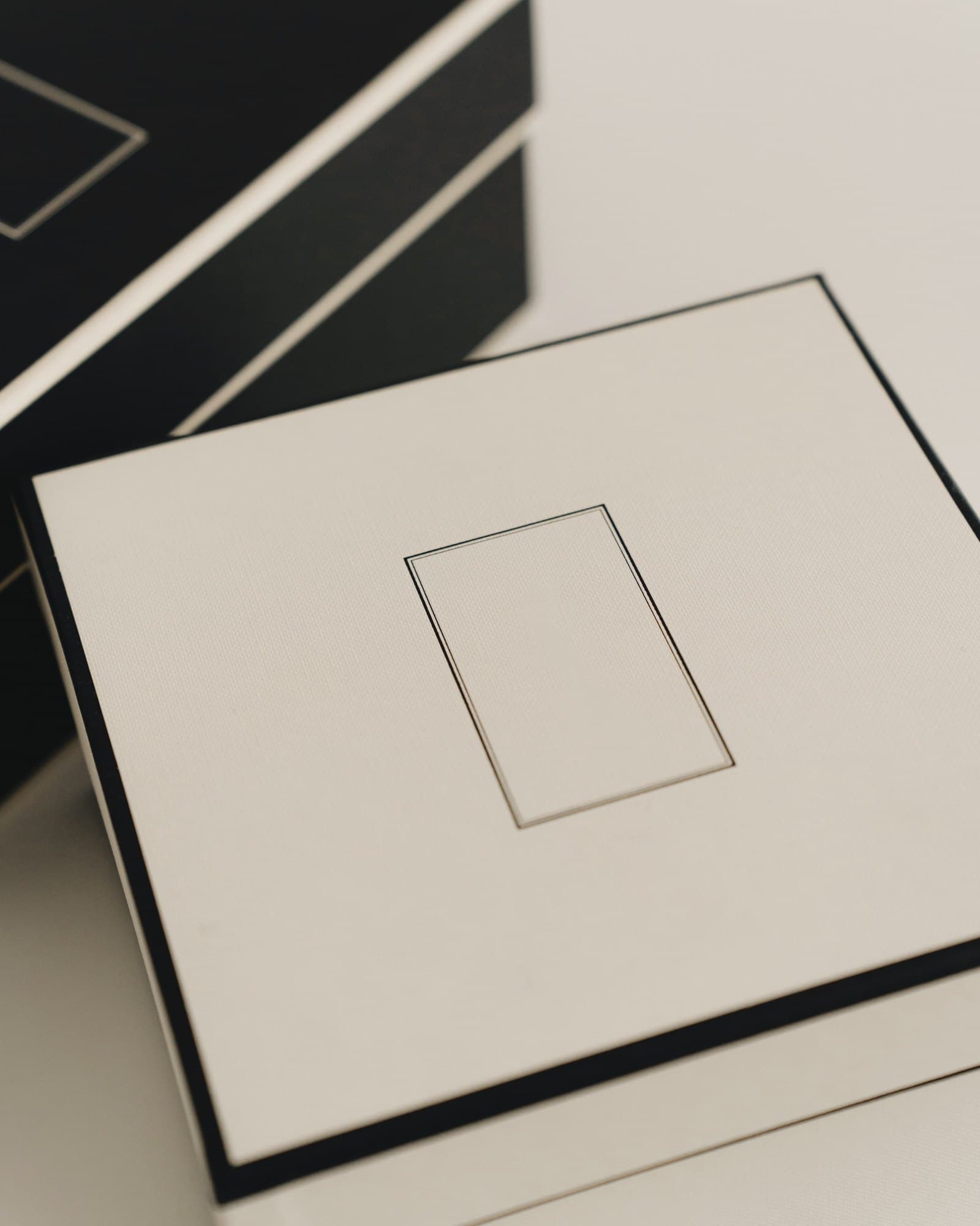 Plain cream paperboard carton with a black edge